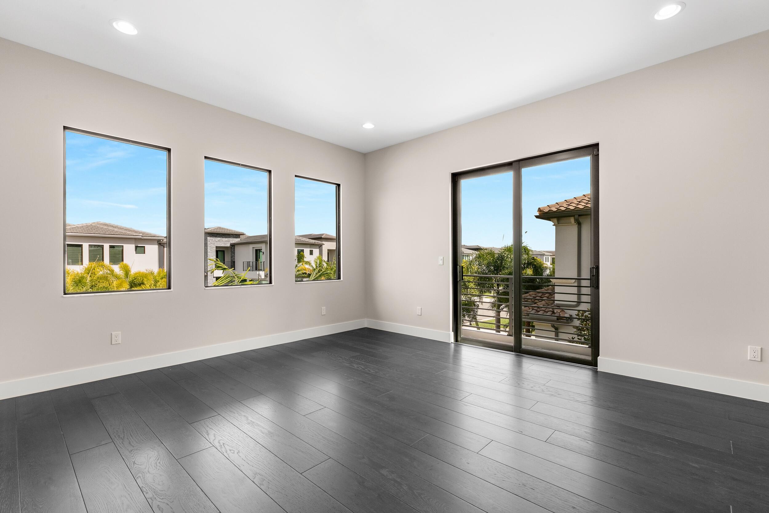 9132 Benedetta Place Boca Raton, FL 33496 - Photo 45 of 50 an empty room with wooden floor and windows