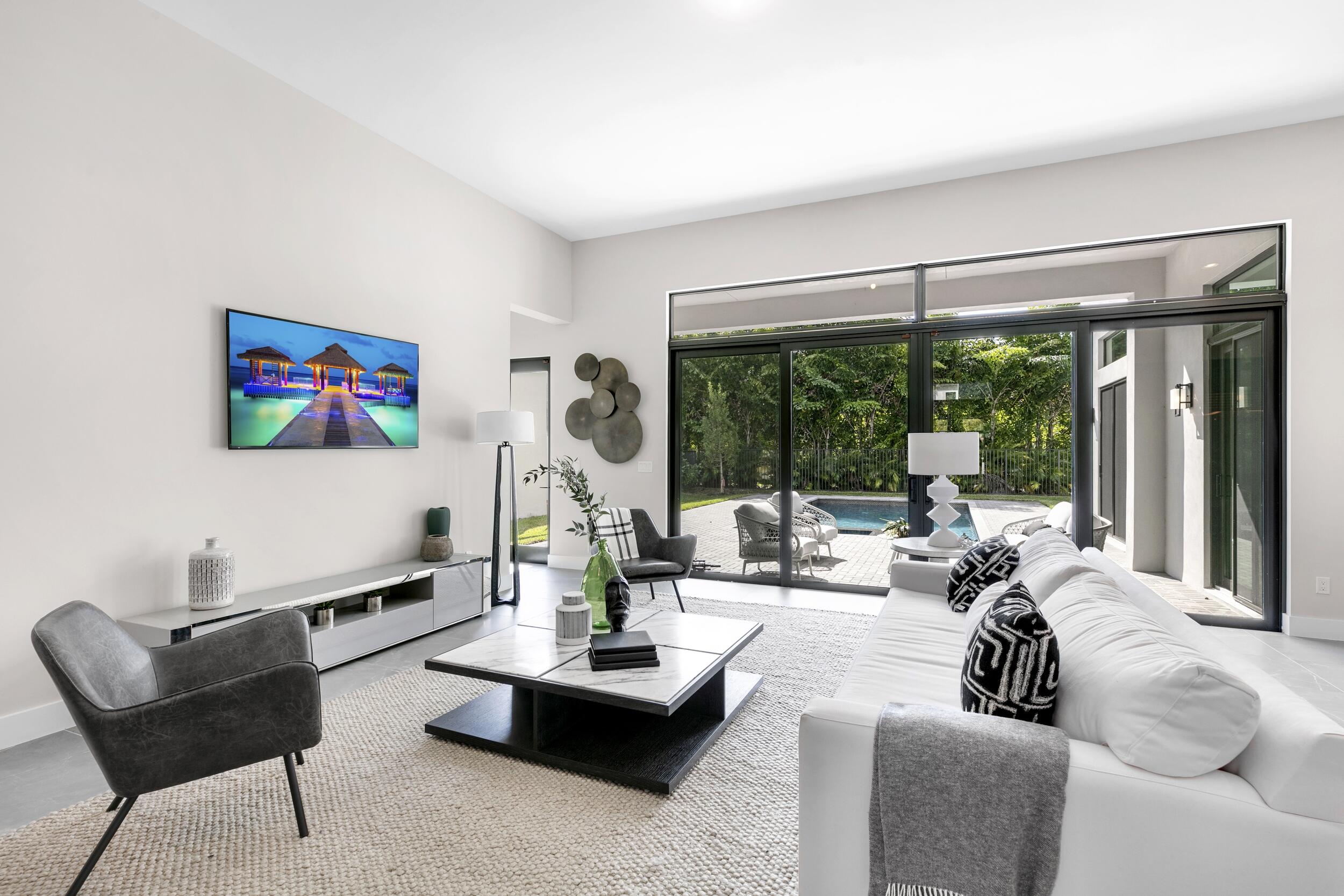 9132 Benedetta Place Boca Raton, FL 33496 - Photo 7 of 50 a living room with fireplace furniture and a large window