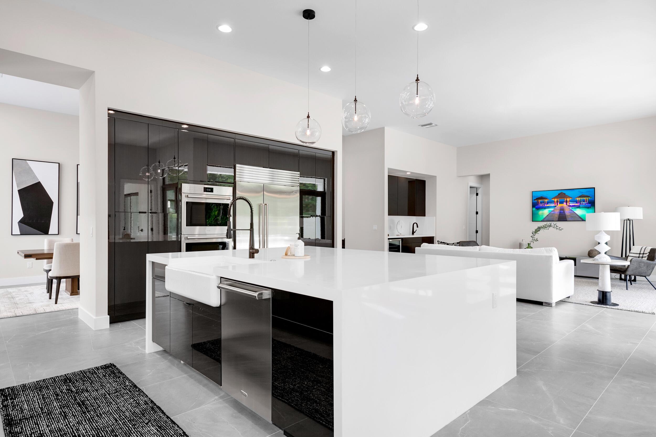 9132 Benedetta Place Boca Raton, FL 33496 - Photo 9 of 50 a large white kitchen with a large window and stainless steel appliances