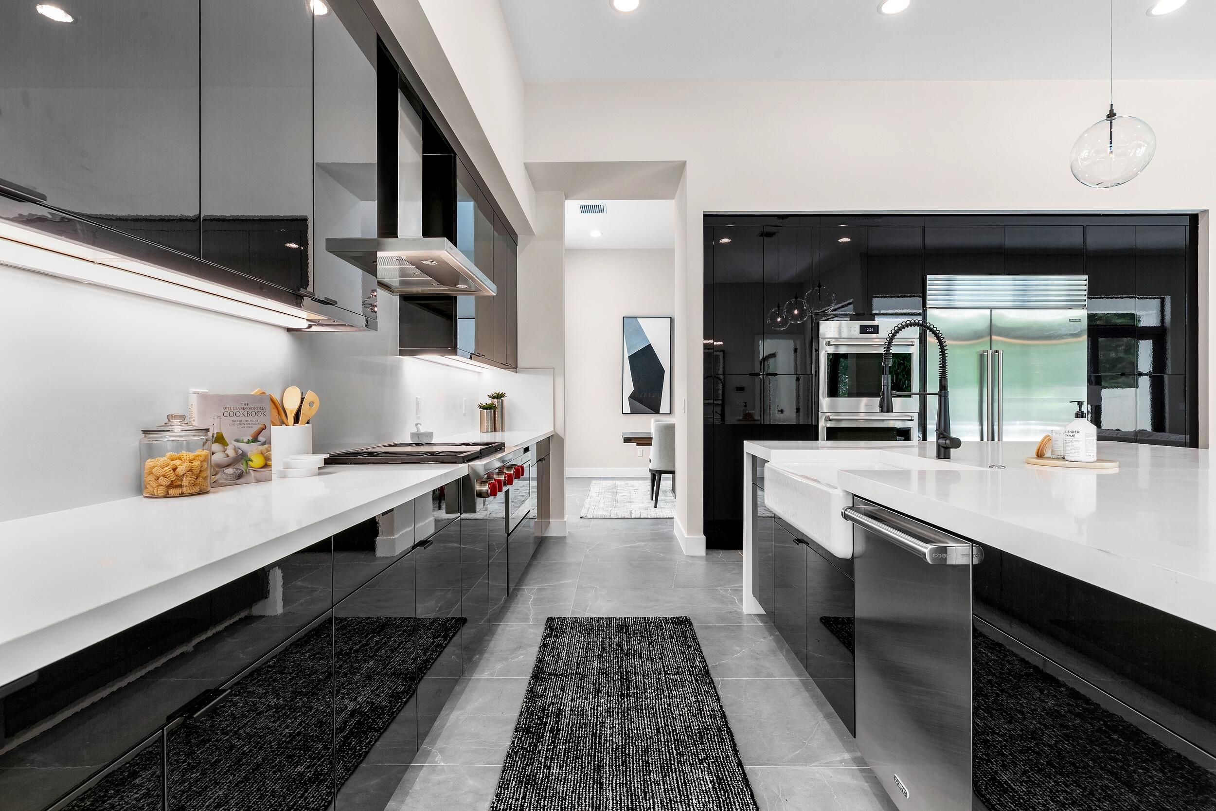 9132 Benedetta Place Boca Raton, FL 33496 - Photo 10 of 50 a kitchen with stainless steel appliances a sink stove and cabinets