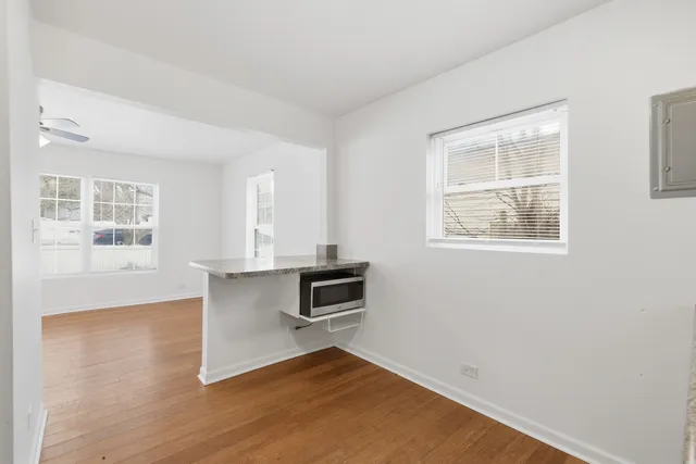 a view of a room with wooden floor and windows