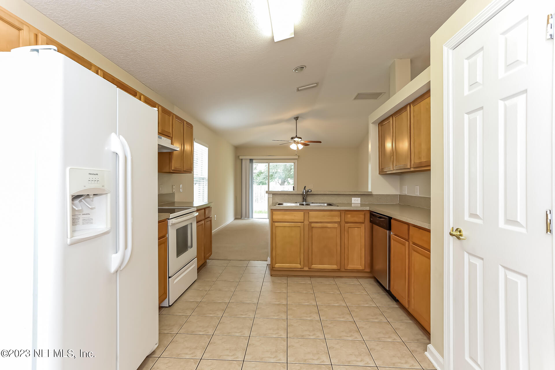 11739 Raindrop Road Jacksonville, FL 32219 - Photo 8 of 19 a kitchen with a refrigerator and a sink