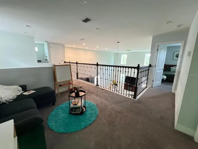 a view of living room kitchen with furniture and a fireplace