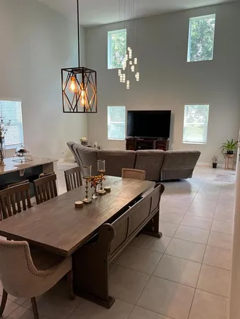 a view of a dining room with furniture and chandelier