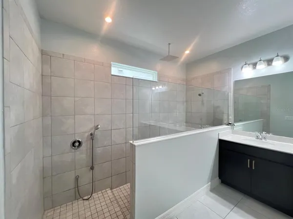 a bathroom with a double vanity sink toilet and shower