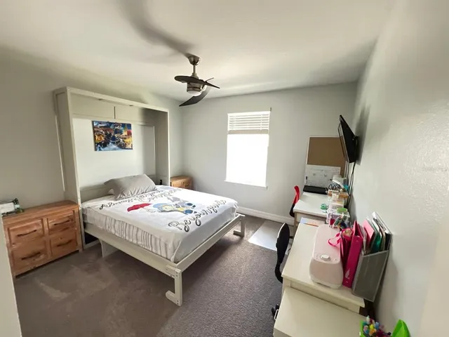 a bedroom with a bed and a window