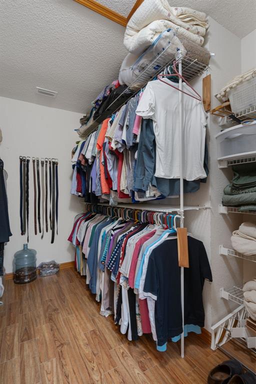 5035 Harbinger Road Spring Hill, FL 34608 - Photo 37 of 47 a view of walk in closet with clothes and shoes
