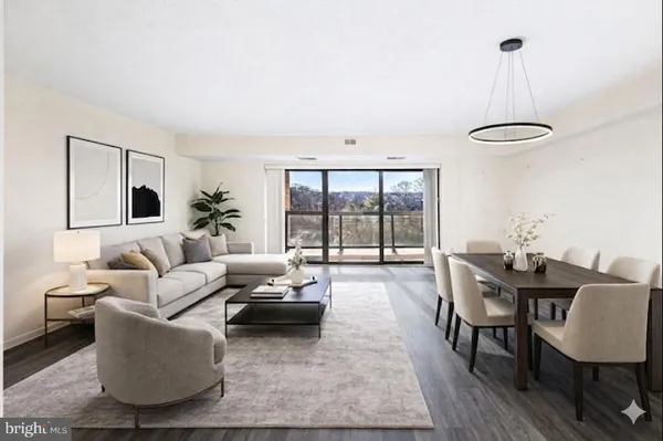 a living room with furniture a window and a table