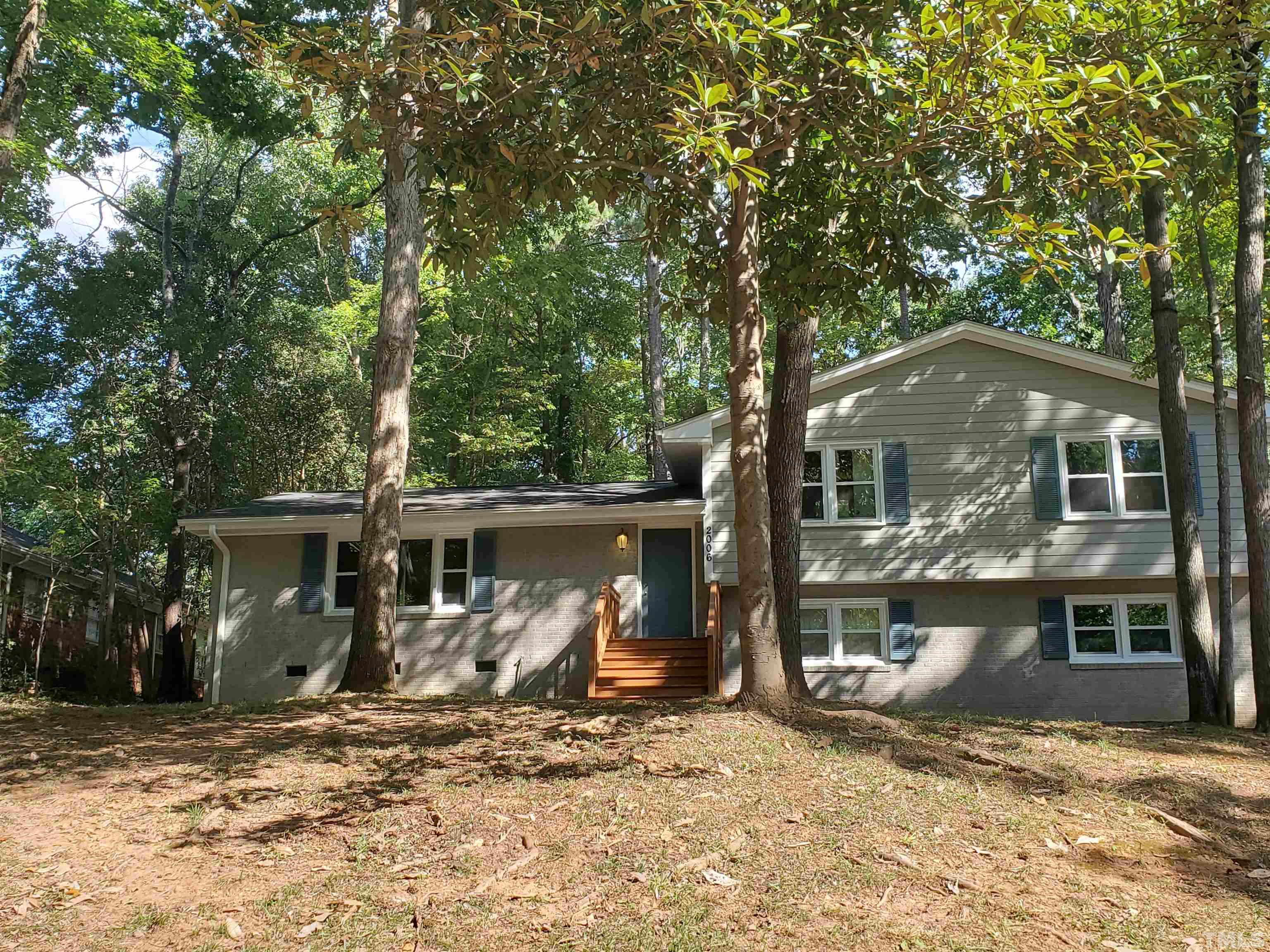 2006 Myron Drive Raleigh, NC 27607 - Photo 1 of 28 a view of a house with large tree and wooden fence