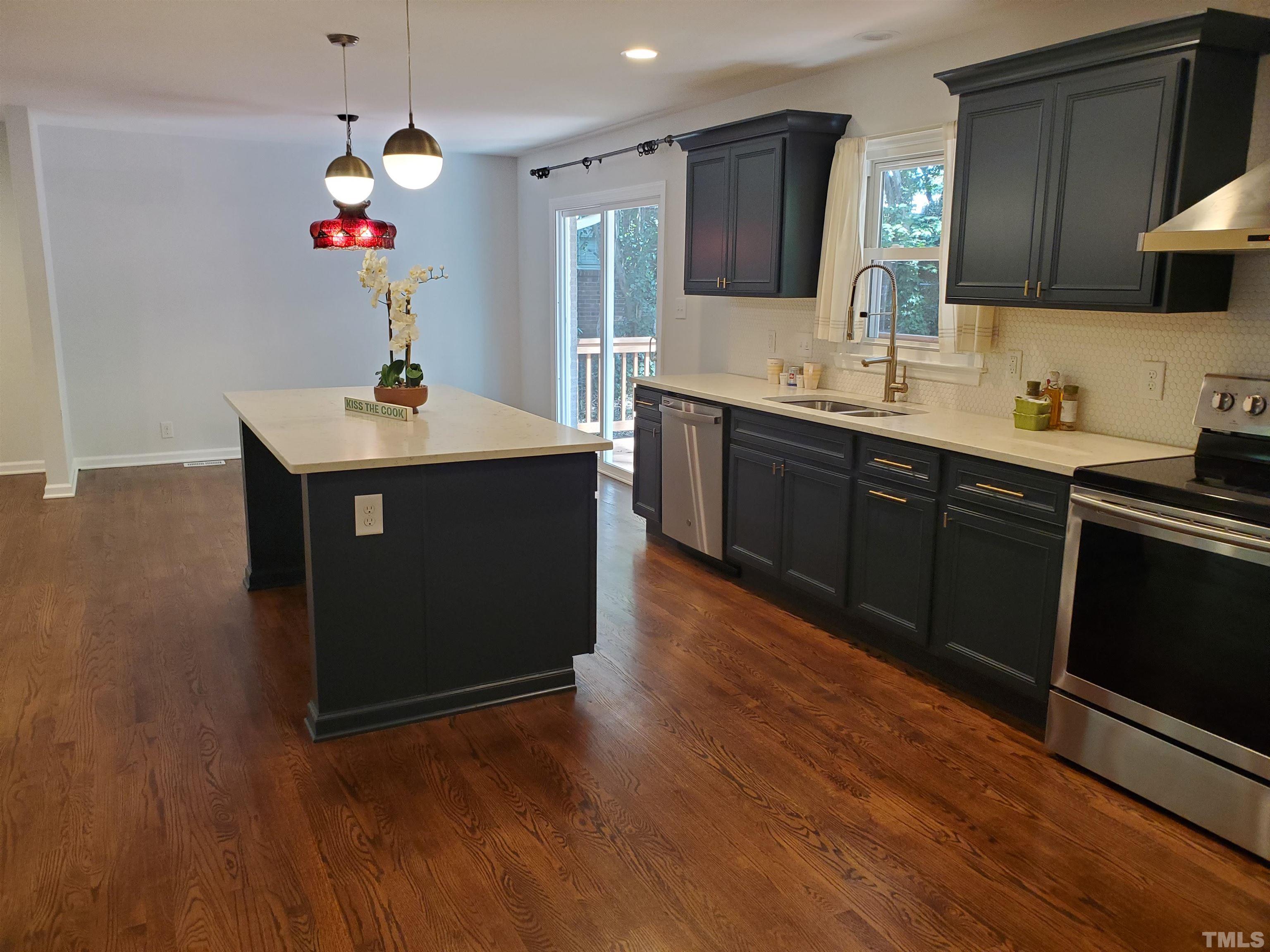 2006 Myron Drive Raleigh, NC 27607 - Photo 6 of 28 a kitchen with wooden floor and cabinets