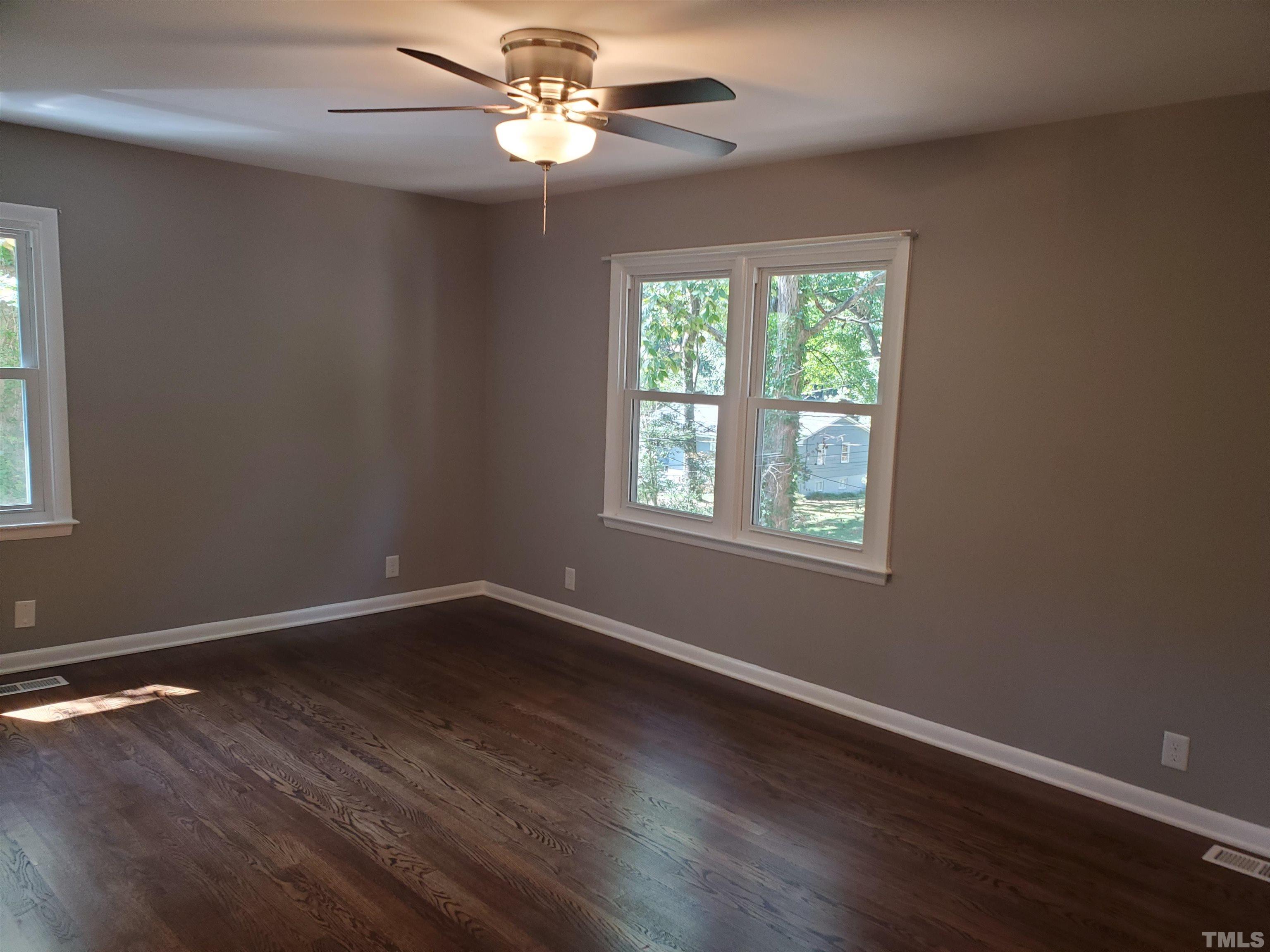 2006 Myron Drive Raleigh, NC 27607 - Photo 9 of 28 a view of an empty room with wooden floor and a window