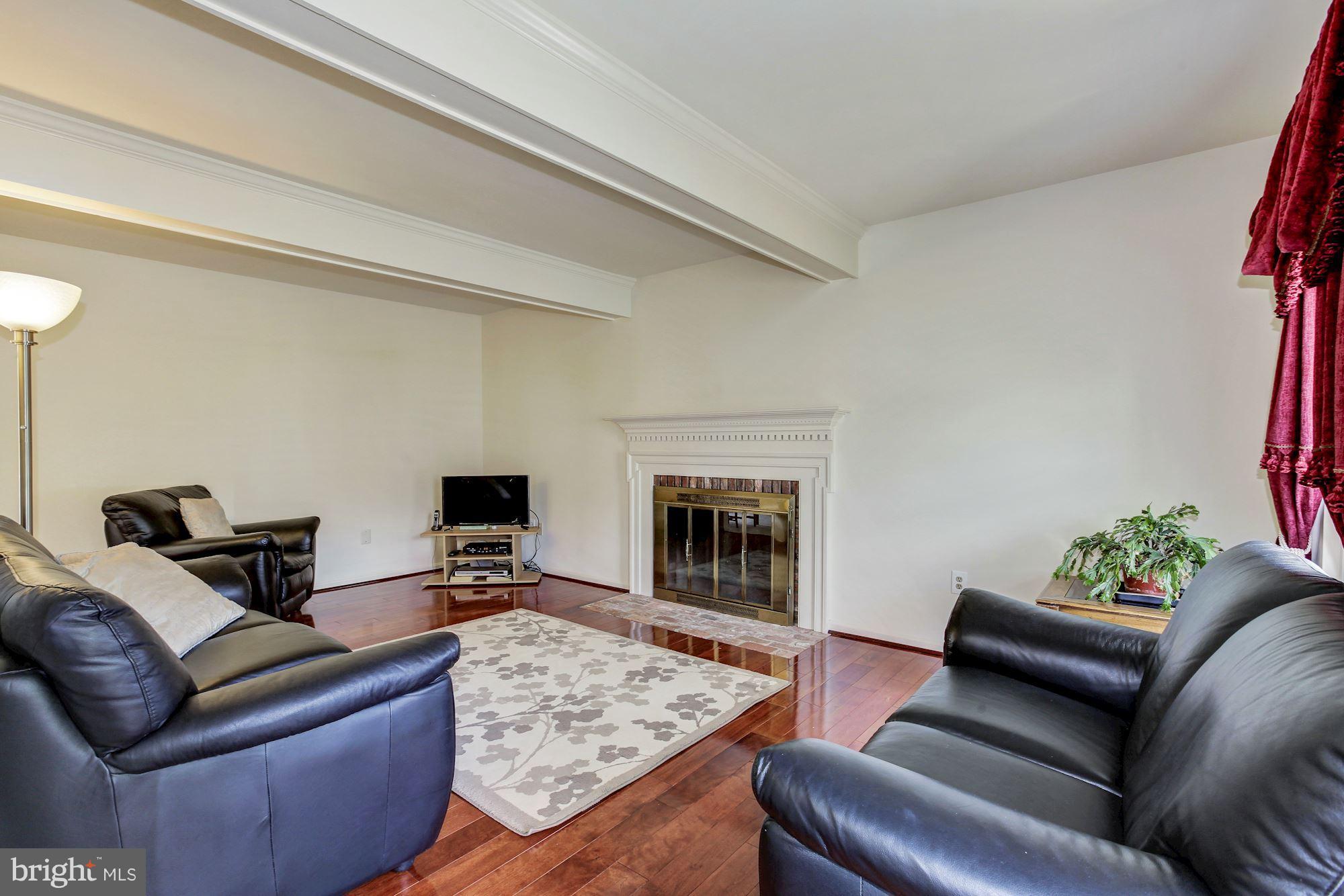 1611 Spottsworth Way Silver Spring, MD 20905 - Photo 11 of 30 Family room, wood burning fireplace with mantel