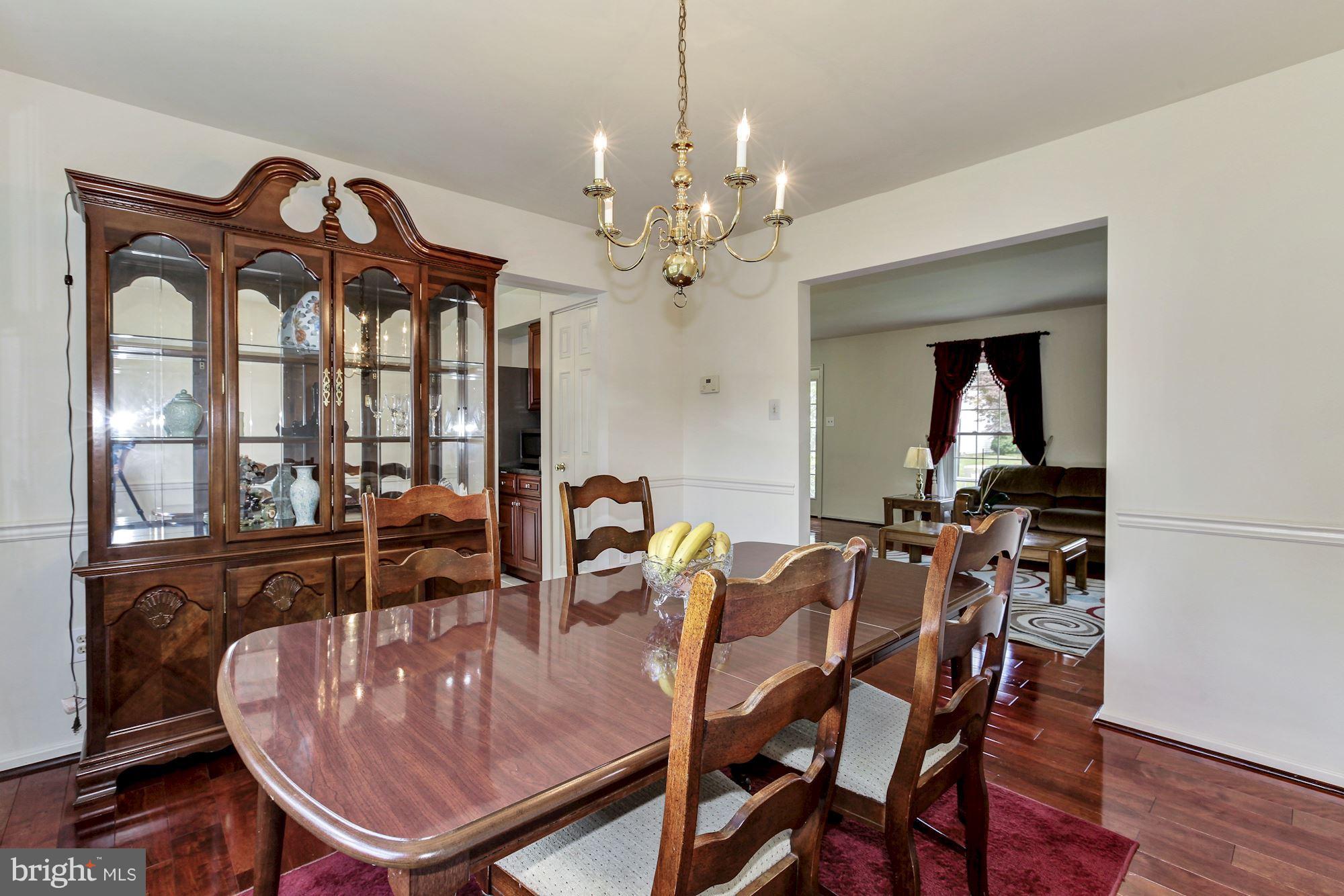 1611 Spottsworth Way Silver Spring, MD 20905 - Photo 10 of 30 Dining room with hardwoods, chair rail molding