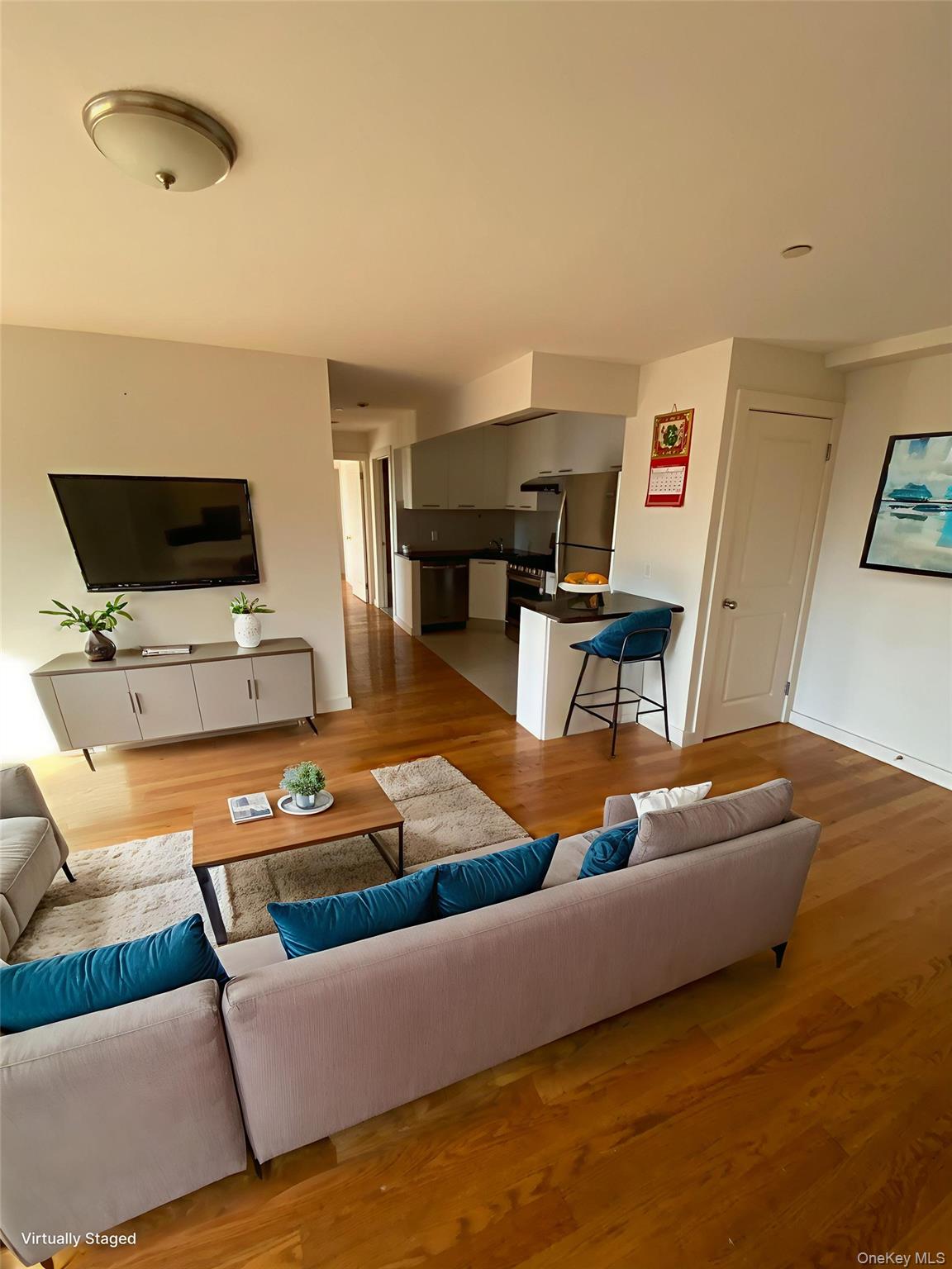 132-35 41st Road, Unit 10D Queens, NY 11355 - Photo 5 of 18 a living room with furniture and a flat screen tv