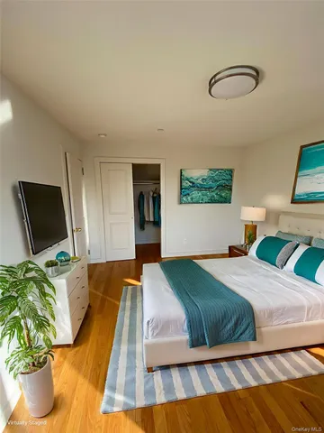 a bedroom with a bed and a painting on the wall