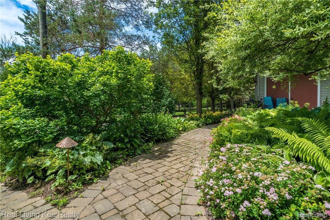 247 Whims Court Rochester, MI 48306 - Photo 47 of 57 Beautiful perennial gardens and paths around the home. Feels like vacation in your own back yard!