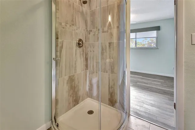 a bathroom with a tub and shower