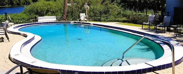 a view of swimming pool with a chairs