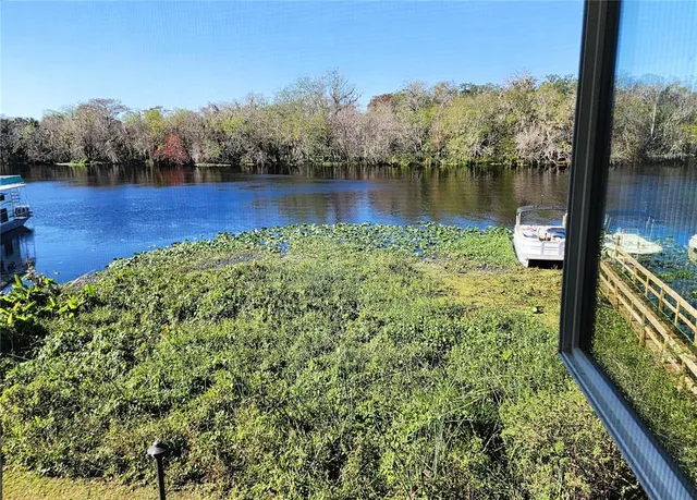 a view of a lake with houses in the back