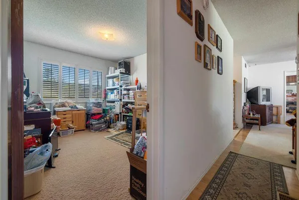 a view of a hallway with bathroom and wooden floor