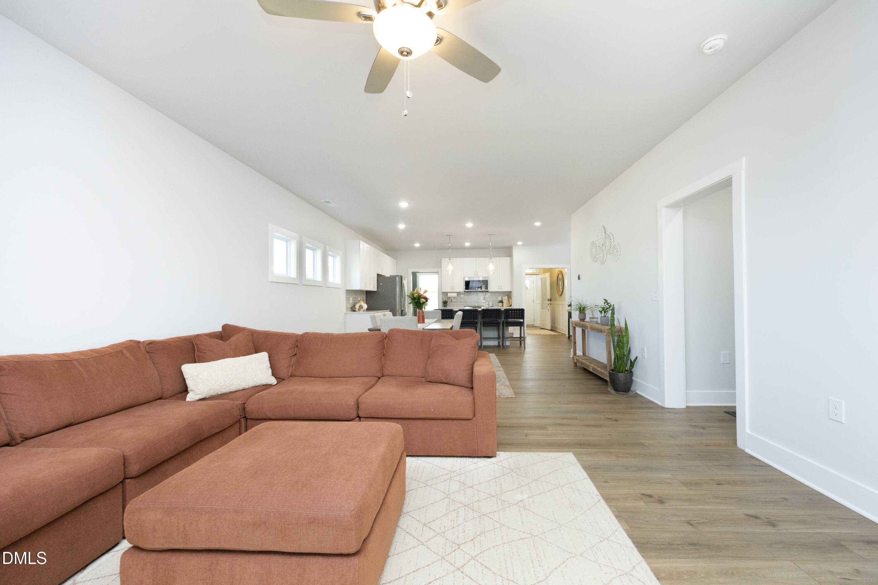 91 Kitty Br Way Clayton, NC 27520 - Photo 19 of 51 a living room with furniture and a chandelier