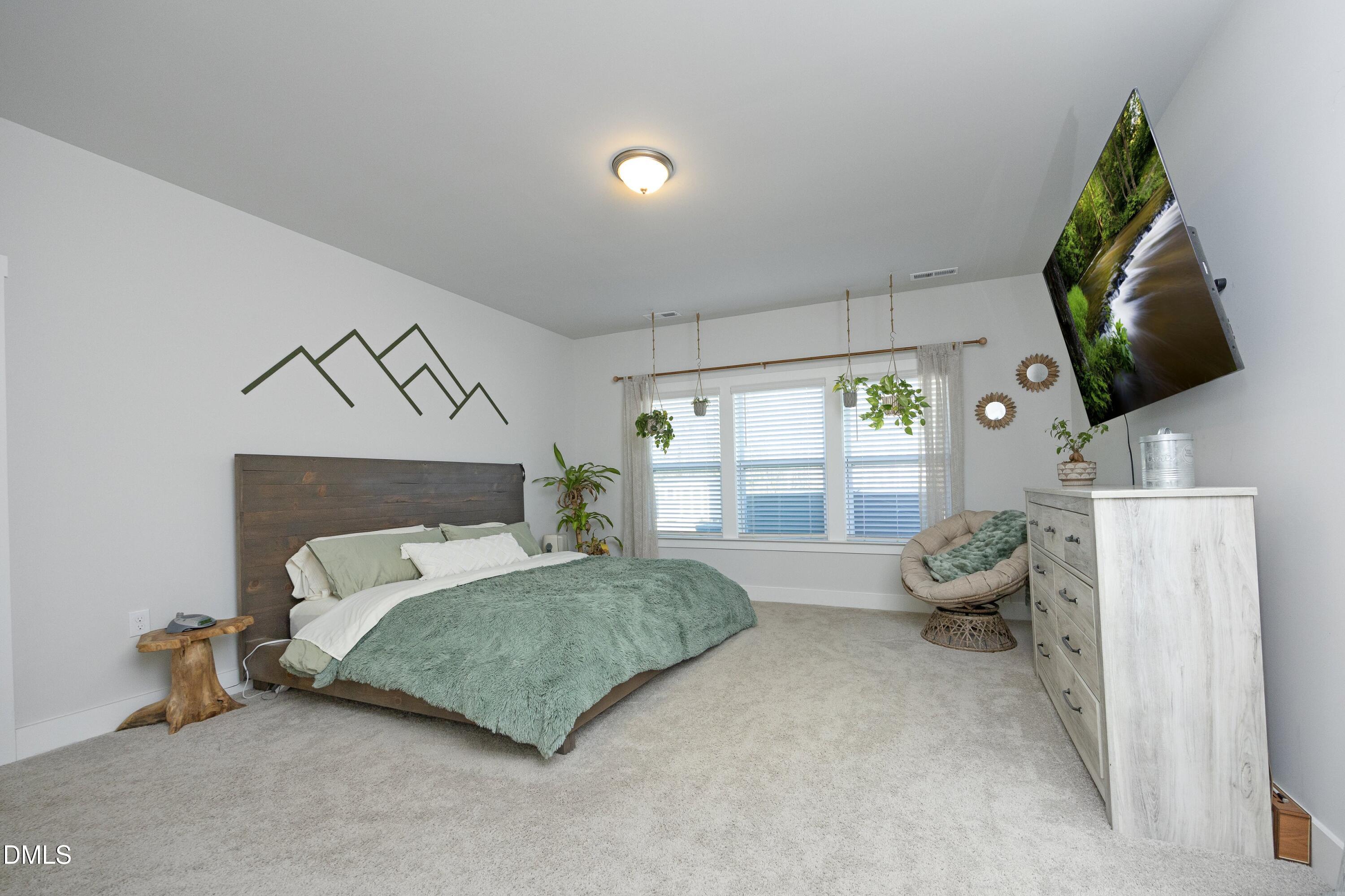 91 Kitty Br Way Clayton, NC 27520 - Photo 20 of 51 a bedroom with a bed and large window