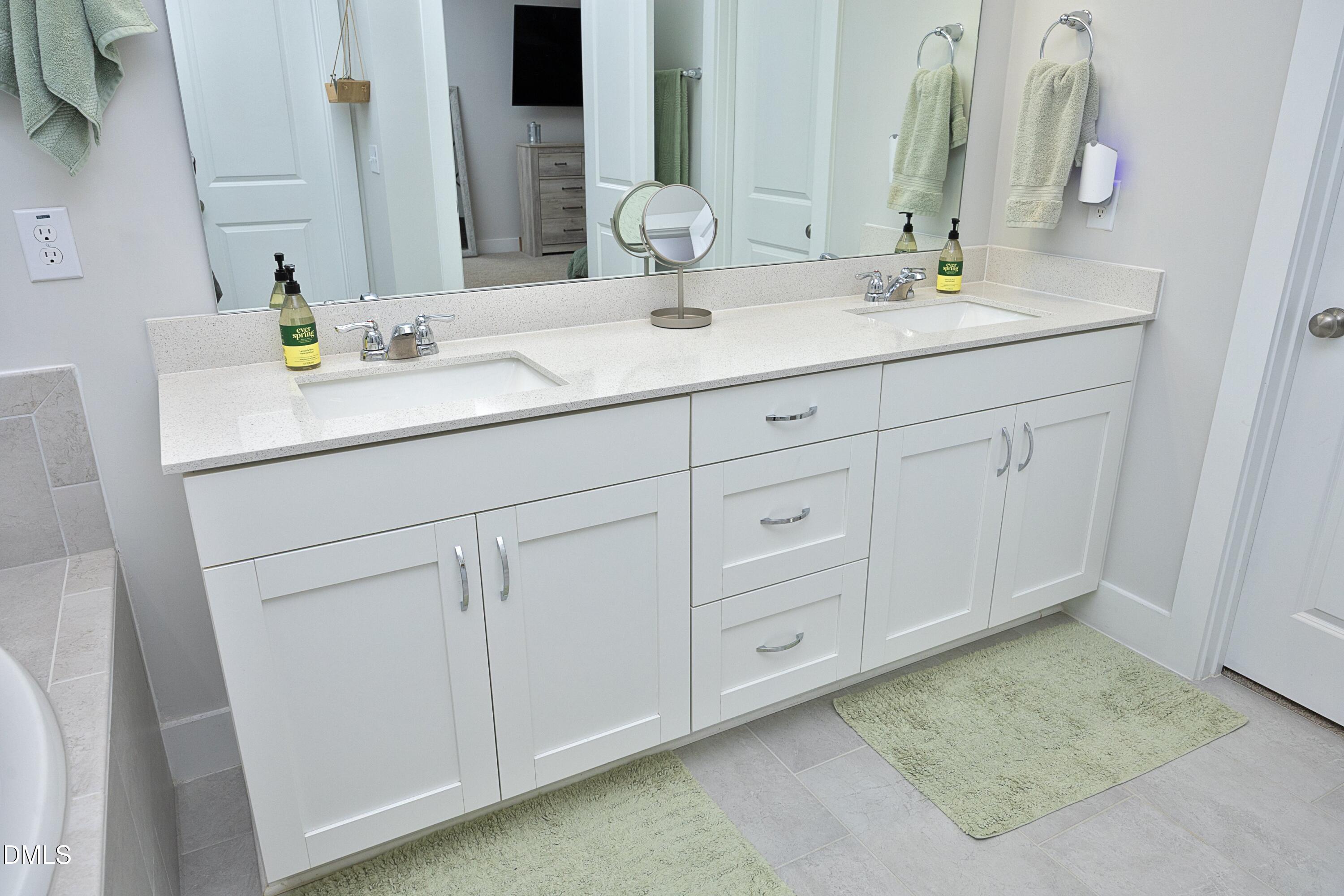 91 Kitty Br Way Clayton, NC 27520 - Photo 24 of 51 a bathroom with a sink and a mirror