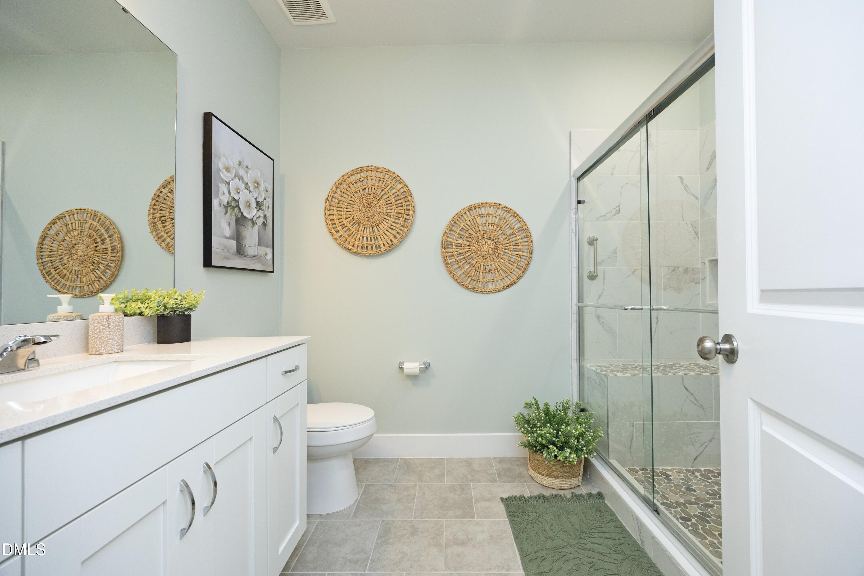91 Kitty Br Way Clayton, NC 27520 - Photo 26 of 51 a bathroom with a toilet a sink and mirror