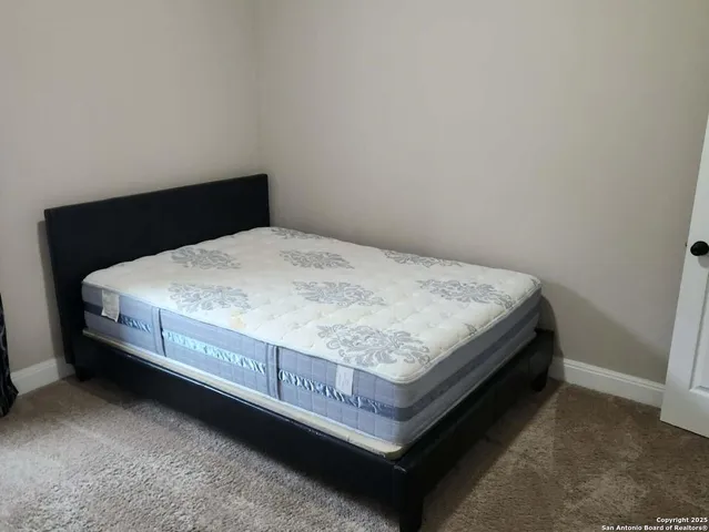 a bed sitting in a bedroom next to a window