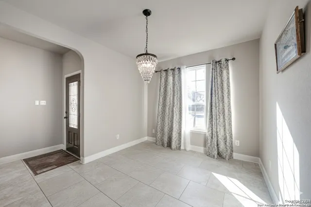 a view of a room with window and chandelier