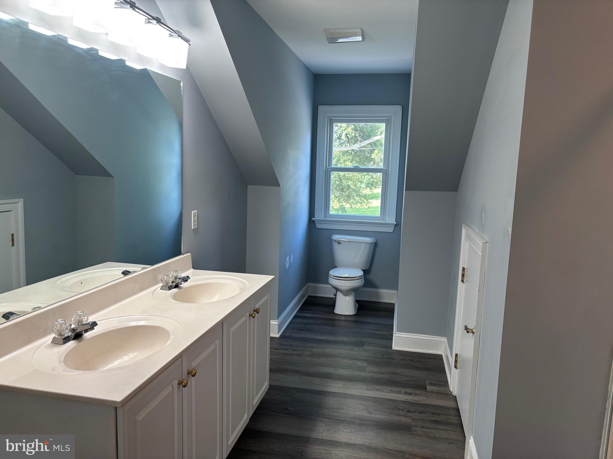 629 Country Club Road Culpeper, VA 22701 - Photo 21 of 27 a spacious bathroom with a double vanity sink a mirror and a toilet