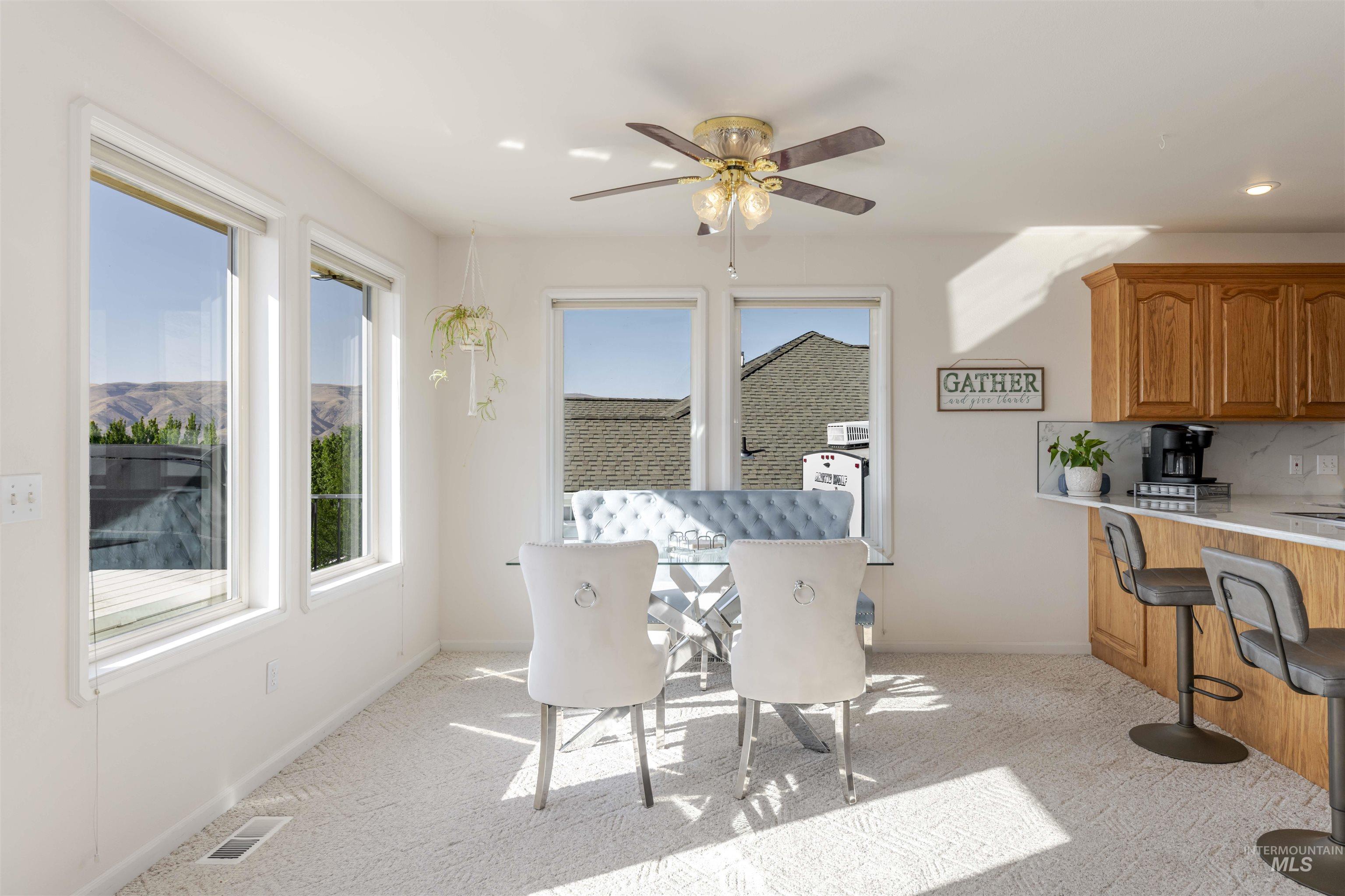 331 Reservoir Drive Lewiston, ID 83501 - Photo 11 of 42 Dining room with light colored carpet and a ceiling fan