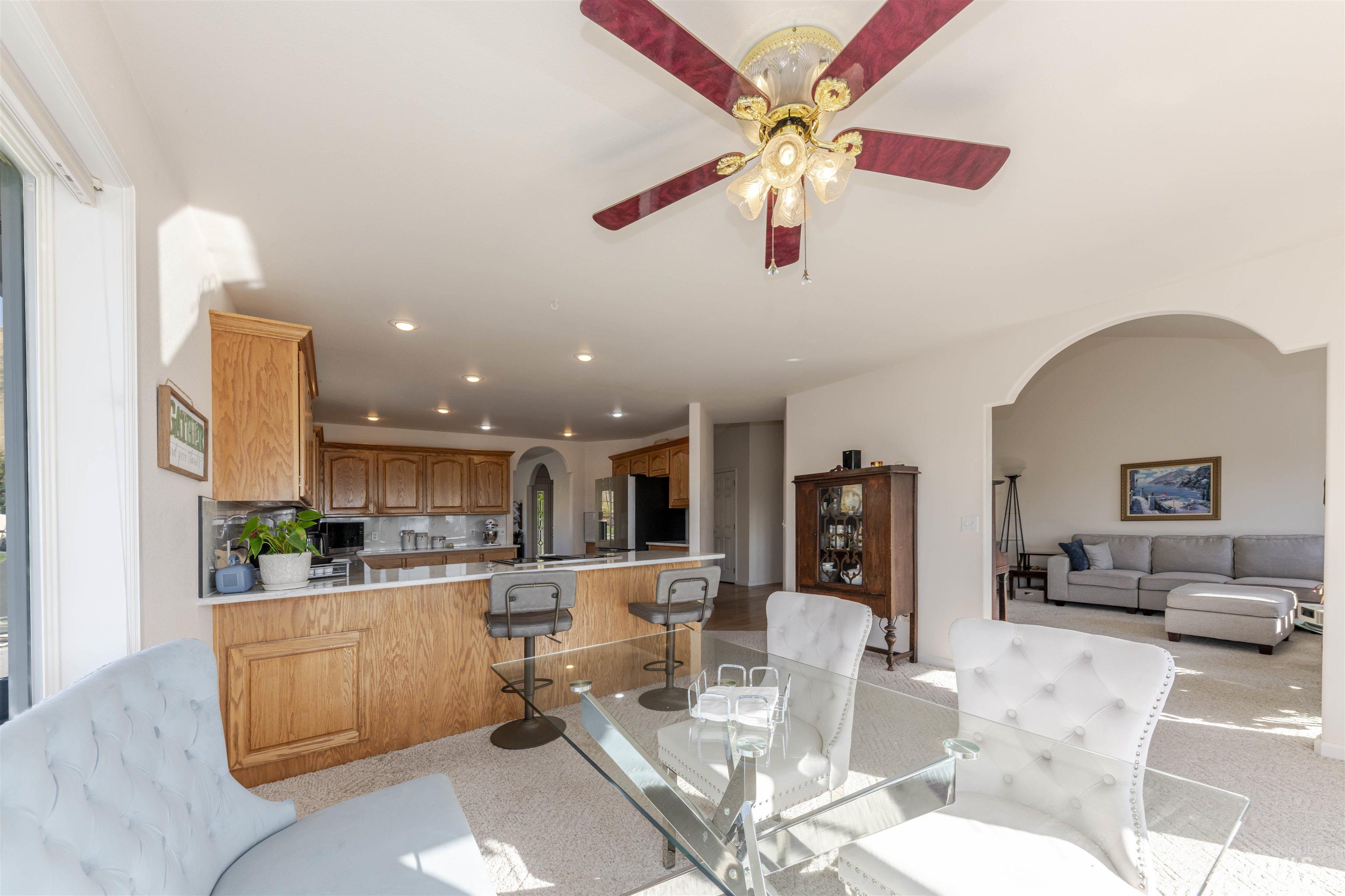 331 Reservoir Drive Lewiston, ID 83501 - Photo 13 of 42 Dining space with arched walkways, light colored carpet, recessed lighting, and a ceiling fan