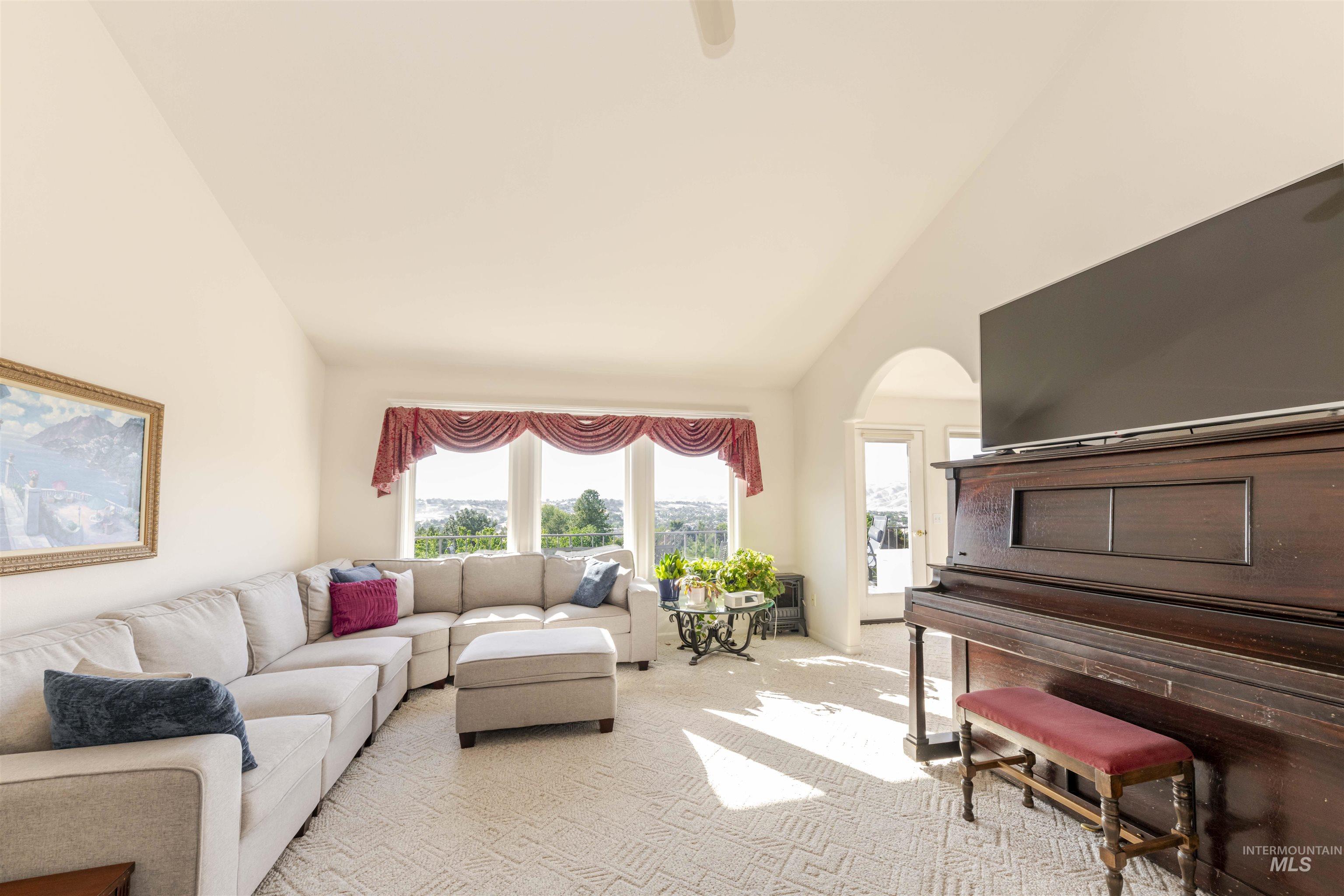 331 Reservoir Drive Lewiston, ID 83501 - Photo 15 of 42 Living room with carpet, high vaulted ceiling, and arched walkways