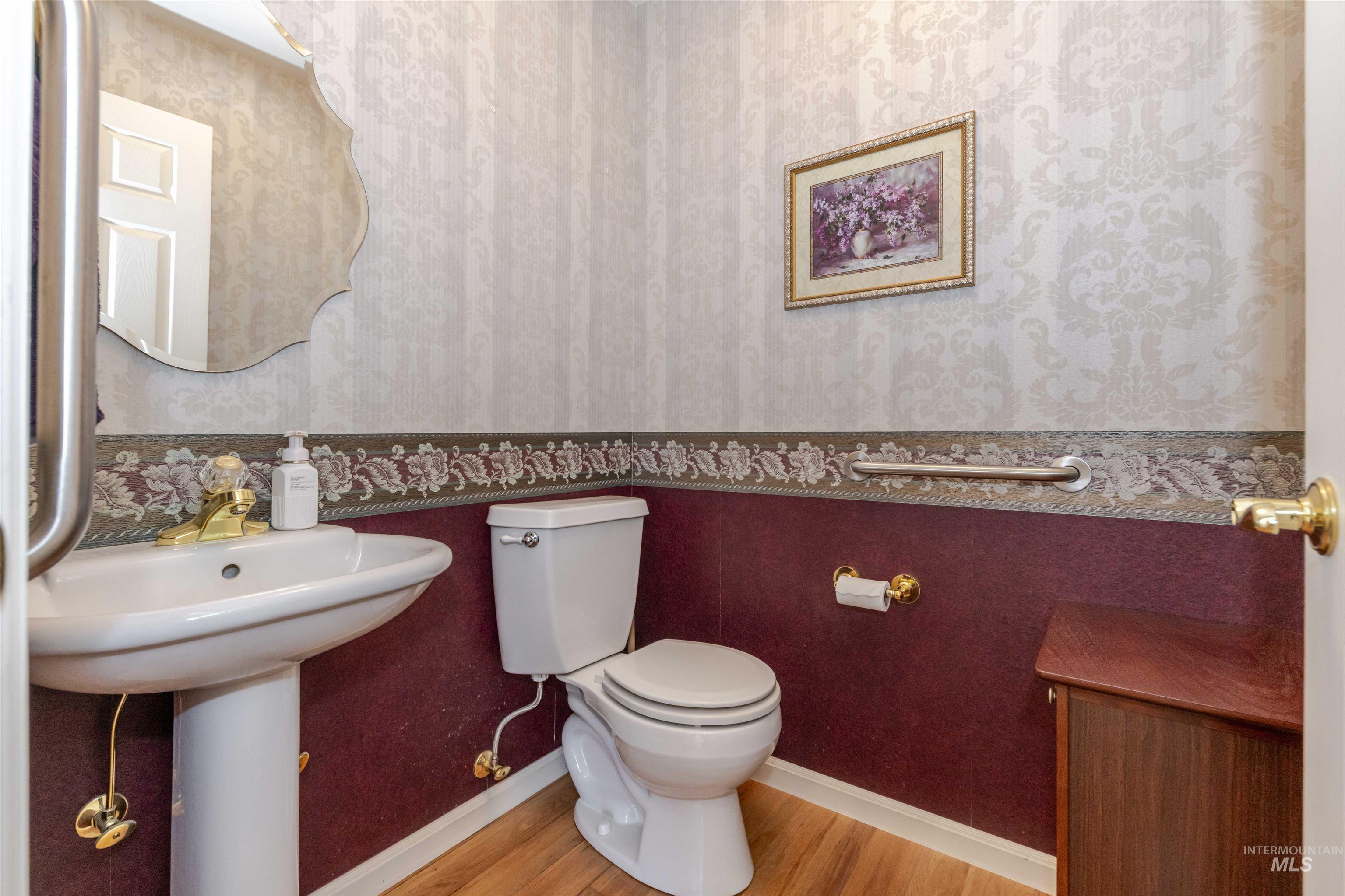 331 Reservoir Drive Lewiston, ID 83501 - Photo 17 of 42 Half bath featuring wallpapered walls and wood finished floors
