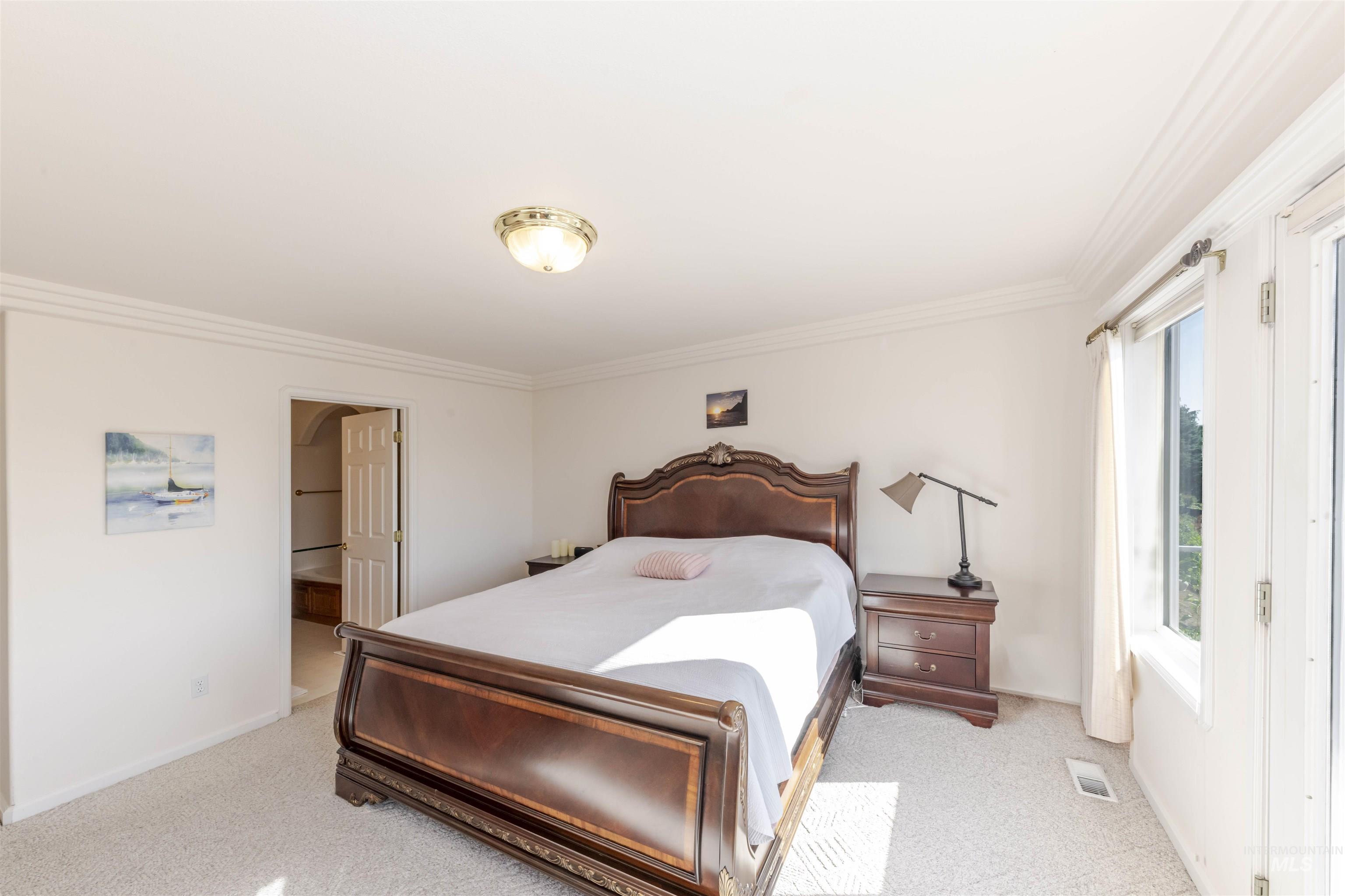 331 Reservoir Drive Lewiston, ID 83501 - Photo 20 of 42 Bedroom with crown molding, light colored carpet, and connected bathroom