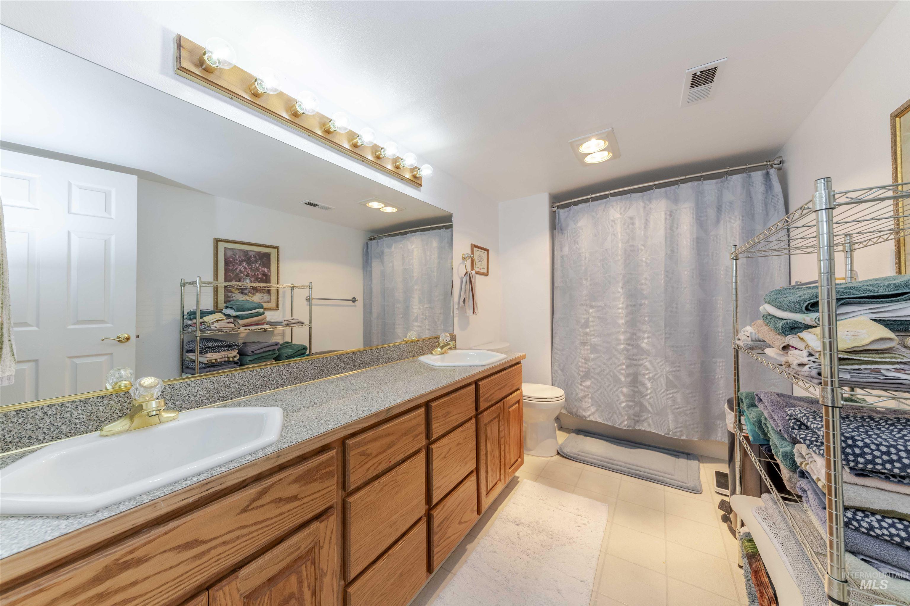 331 Reservoir Drive Lewiston, ID 83501 - Photo 24 of 42 Full bathroom with double vanity, a shower with curtain, light tile patterned flooring, and recessed lighting
