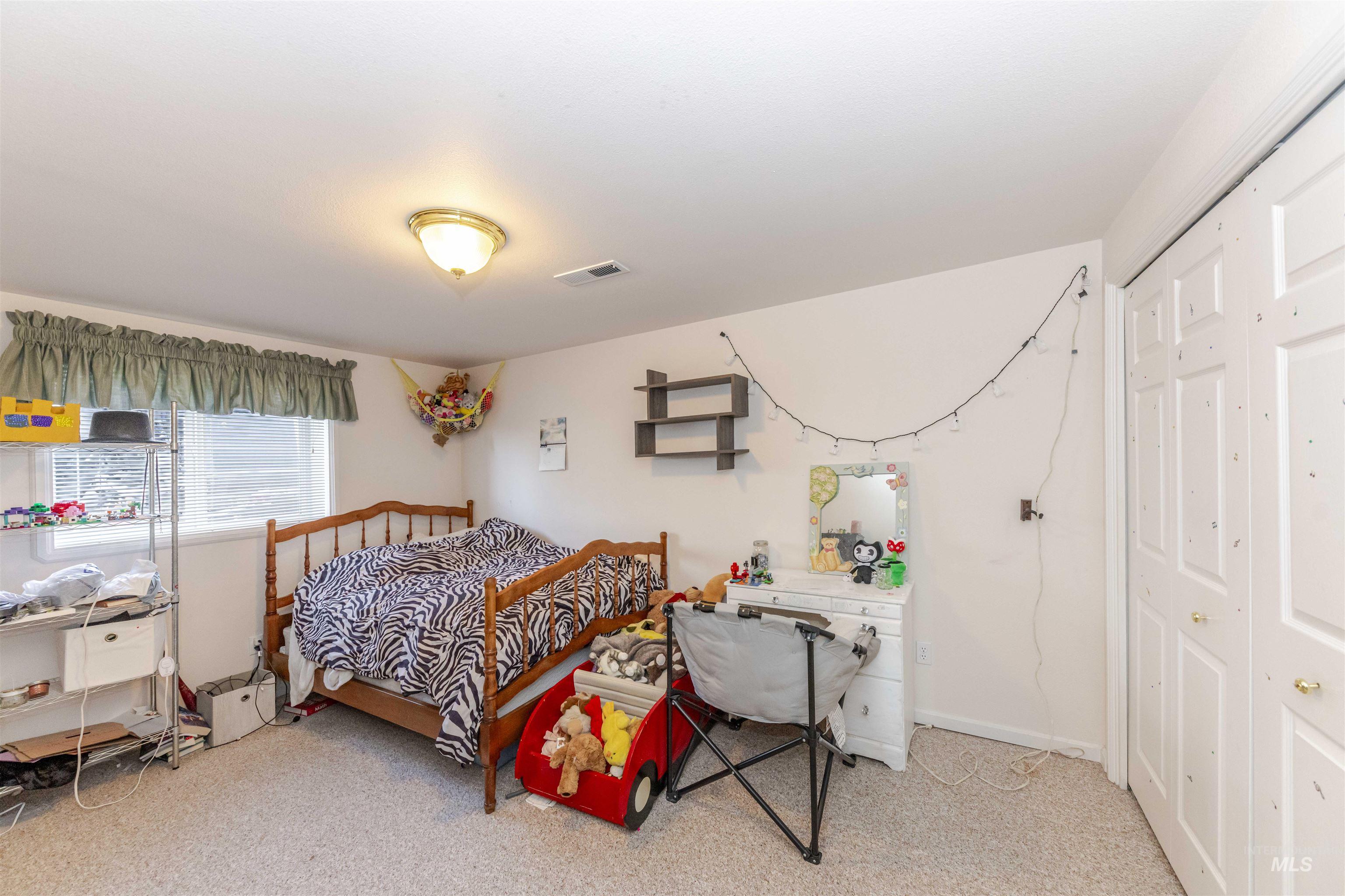 331 Reservoir Drive Lewiston, ID 83501 - Photo 26 of 42 Bedroom featuring light colored carpet and a closet