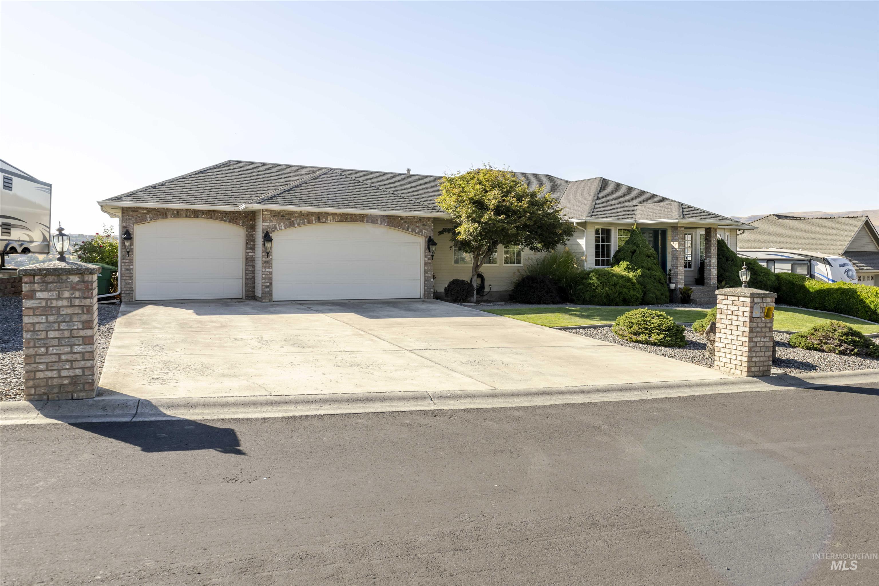 331 Reservoir Drive Lewiston, ID 83501 - Photo 36 of 42 Single story home with roof with shingles, concrete driveway, an attached garage, and brick siding