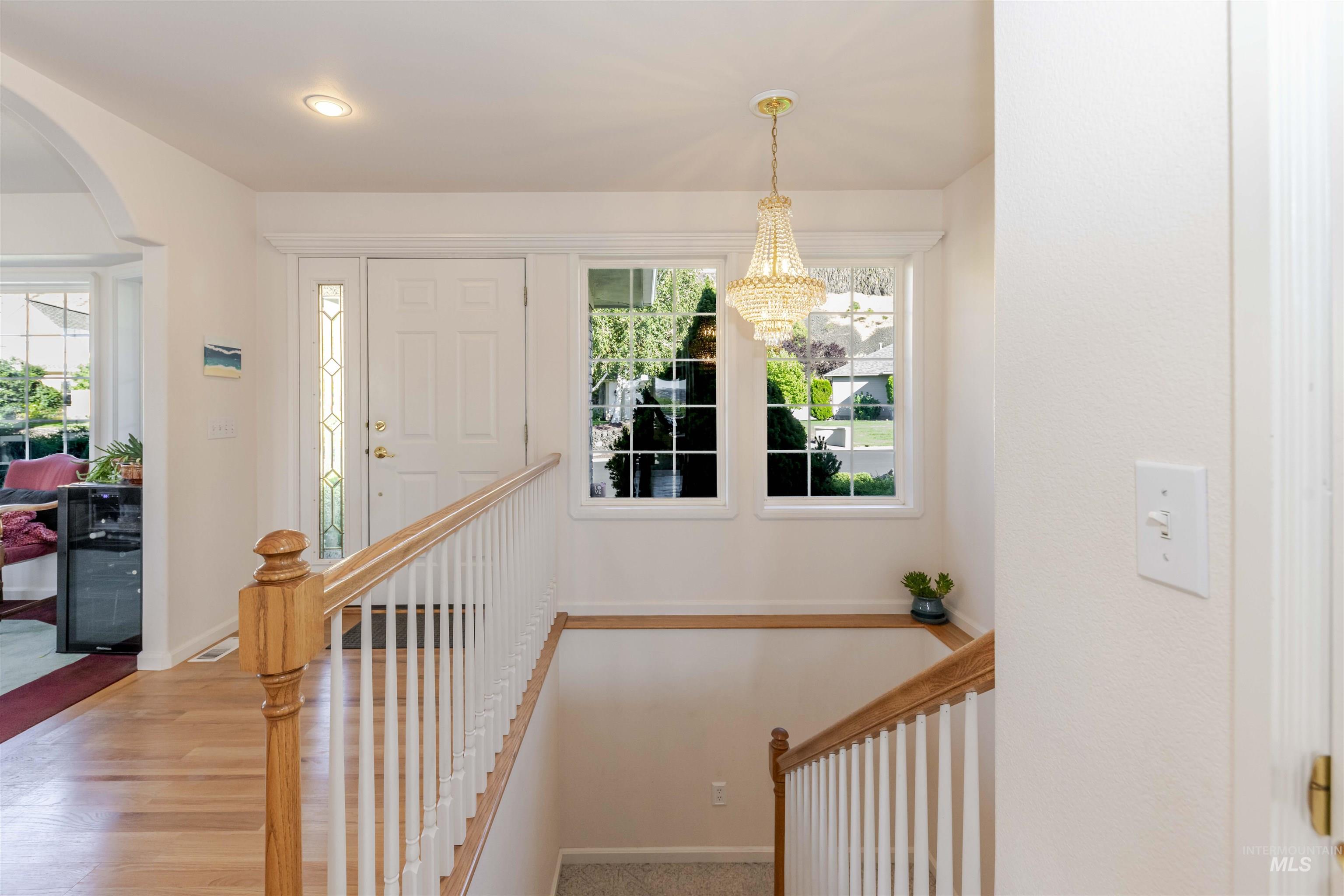 331 Reservoir Drive Lewiston, ID 83501 - Photo 4 of 42 Stairs featuring arched walkways, healthy amount of natural light, and wood finished floors