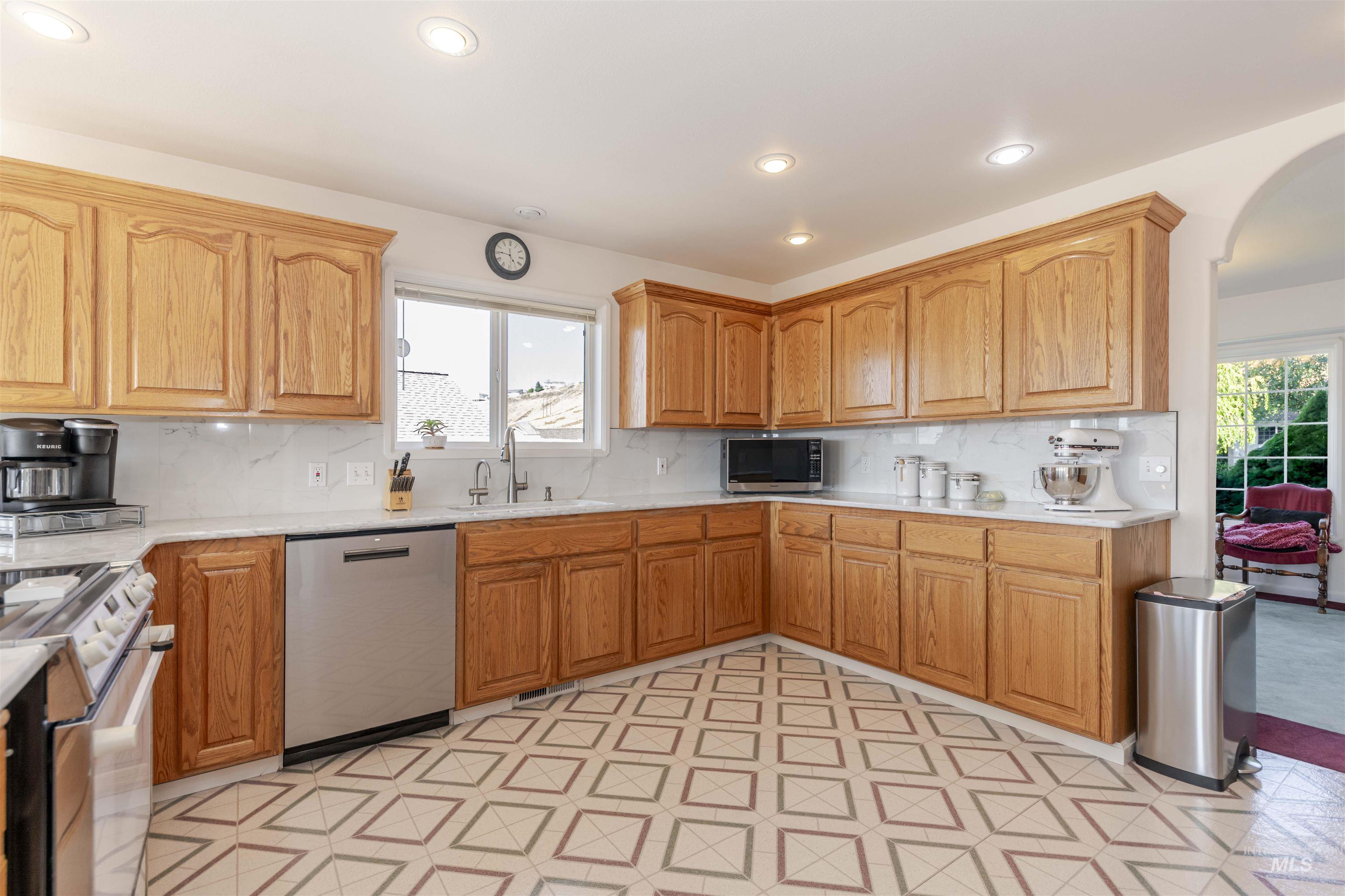 331 Reservoir Drive Lewiston, ID 83501 - Photo 7 of 42 Kitchen featuring appliances with stainless steel finishes, decorative backsplash, recessed lighting, and healthy amount of natural light