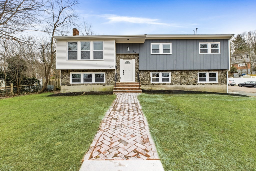 216 Grove Street Randolph, MA 02368 - Photo 1 of 34 a front view of a house with a yard