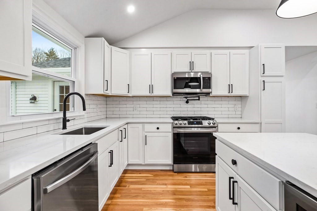 216 Grove Street Randolph, MA 02368 - Photo 11 of 34 a kitchen with cabinets a sink and appliances
