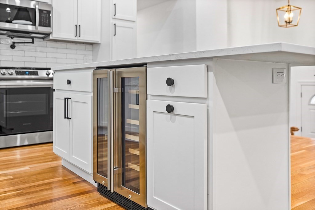 216 Grove Street Randolph, MA 02368 - Photo 12 of 34 a kitchen with stainless steel appliances a refrigerator and a stove