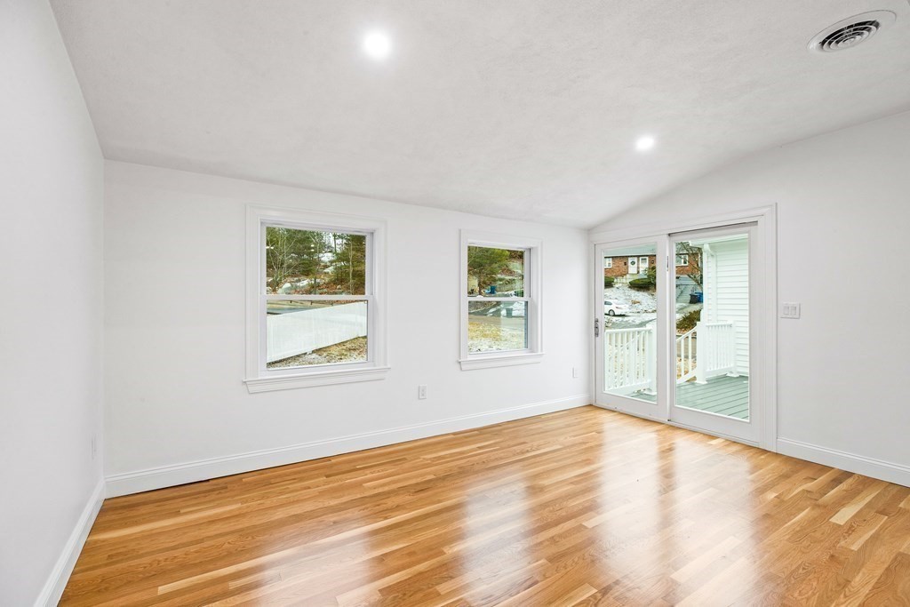 216 Grove Street Randolph, MA 02368 - Photo 14 of 34 a view of empty room with wooden floor and fan