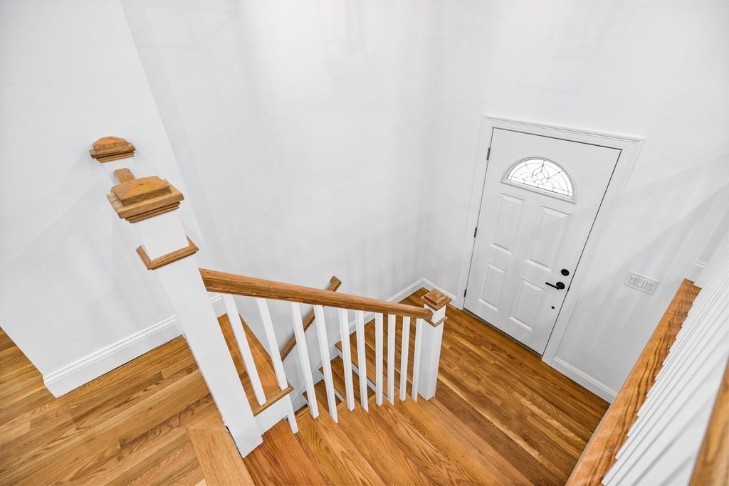 216 Grove Street Randolph, MA 02368 - Photo 15 of 34 a view of a hallway with wooden floor and stairs