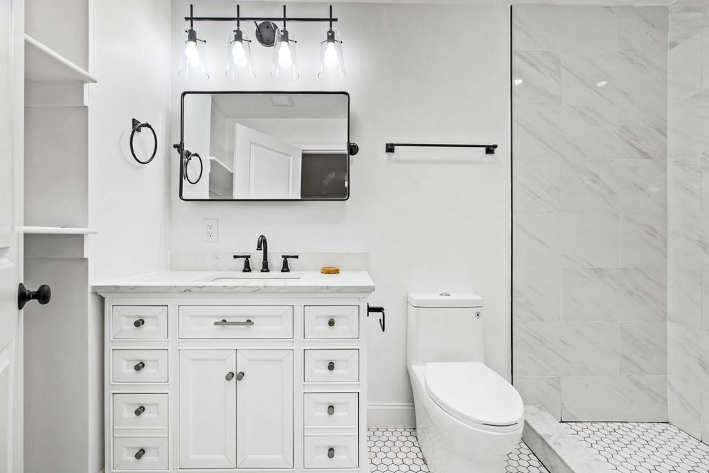 216 Grove Street Randolph, MA 02368 - Photo 19 of 34 a bathroom with a granite countertop toilet sink and mirror