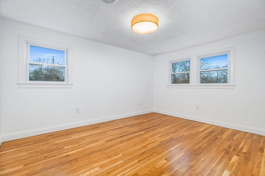 216 Grove Street Randolph, MA 02368 - Photo 21 of 34 a view of empty room with wooden floor and fan