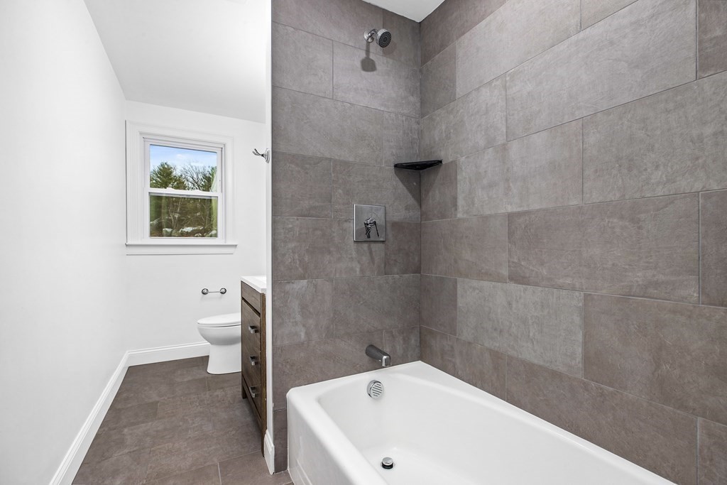 216 Grove Street Randolph, MA 02368 - Photo 22 of 34 a white bath tub sitting next to a white toilet