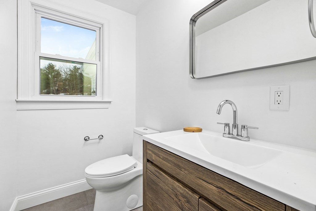 216 Grove Street Randolph, MA 02368 - Photo 23 of 34 a bathroom with a sink a toilet and mirror